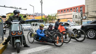 China wheelchair users claim outdoors with hand-cranked bikes